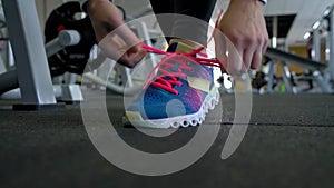 Running shoes - woman tying shoe laces in the gym