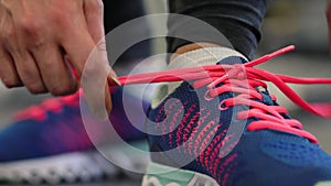 Running shoes - woman tying shoe laces in the gym