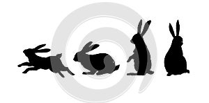 Running, sitting and standing rabbit. Black cut silhouette on a