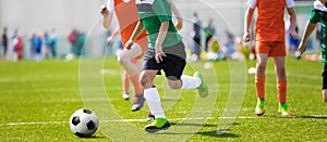 Running Soccer Football Players. Footballers Kicking Football Match; Young Soccer Players Running the Ball