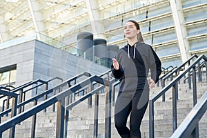 Running on the steps is a young pretty athlete