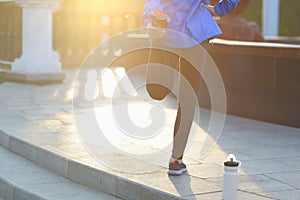 Running stretching - runner wearing smartwatch.