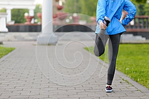 Running stretching - runner wearing smartwatch.