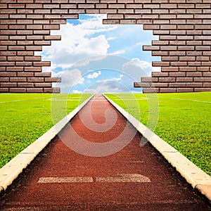 Running track through brick with one lanes to sky
