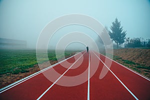 Running track over blue misty sky. Morning run concept photo