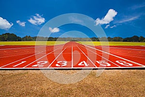 Running track over blue sky and clouds