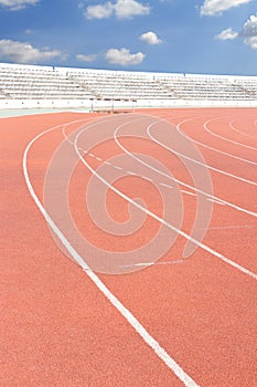Running track over blue sky and clouds