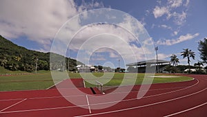 Running track pov red racing tread in football stadium in Caribbean Cook Islands