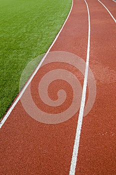 Running track rubber lanes in the artificial grass stadium.