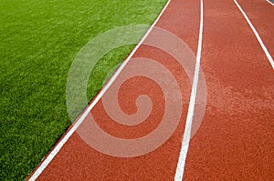 The running track rubber lanes in the artificial grass stadium