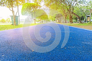 running track in runner rubber cover blue public park. for jogging exercise health lose weight concept copy space add