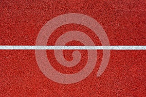 Running track texture.photo of the treadmill cover part in red color.red the texture of the track.White horizontal line on red bac