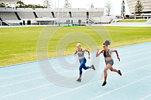 Running, track and women with fitness, training for competition and wellness with endurance. People, runner and athletes