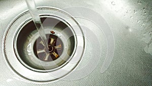 Running Wasting Water Into A Sink Unit