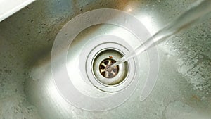 Running Wasting Water Into A Sink Unit