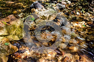 Running water over stones in a stream photo
