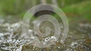 Running water texture up close outside in the late afternoon spring light ripples and waves beautiful. Texture river