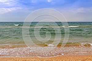 A running wave on the sandy shore