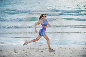 Running woman jogging on beach. Fit woman doing workout on sea sand summer beach. Summer sport. Fitness female sport