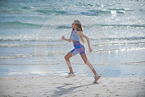 Running woman jogging on beach. Fit woman doing workout on sea sand summer beach. Summer sport. Fitness female sport