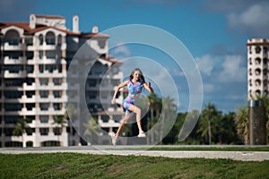 Running woman jogging on South beach, Miami, Florida. Fit woman doing workout on Miami beach. Summer sport. Fitness