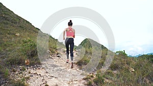 Running woman on mountain road. Sport girl exercising outside in mountains
