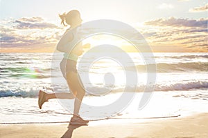 Running woman on sea beach, motion. Girl jogging on sea coast in summer sunny morning. Fitness. Healthy lifestyle