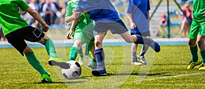Running Young Soccer Football Players. Footballers Kicking Football Match Game photo