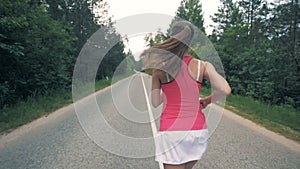 Running young woman in the forest. Healthy slim young sportswoman running.