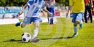 Running Youth Soccer Football Players. Boys Kicking Soccer Match