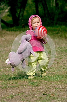 Runnung toddler with a ball photo