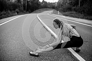 Runnung woman warm-up before jogging. Black and white photo. photo