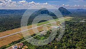 Runway at the airport in Mulu village near tropical forest and mountains near Gunung Mulu national park. Borneo. Sarawak.