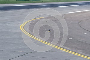 Runway curve at airport with yellow double line