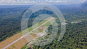 Runway in secluded airport at Mulu village near tropical forest and mountains near Gunung Mulu national park. Borneo. Sarawak.