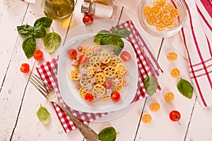 Ruote pasta with tomato and ham.