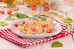 Ruote pasta with tomato and ham.