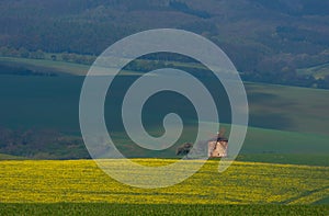 Rural abstract landscape with rolling hills and windmill in South Moravia, Czech Republic