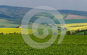 Rural abstract landscape with rolling hills and windmill in South Moravia, Czech Republic