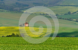 Rural abstract landscape with rolling hills and windmill in South Moravia, Czech Republic