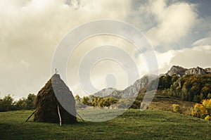 Rural autumn Transylvanian mountain landscape with haystack