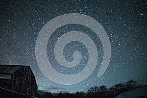 Rural barns at night with stars in winter