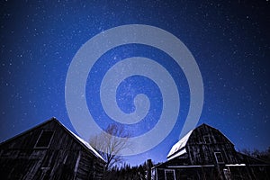 Rural barns at night with stars in winter