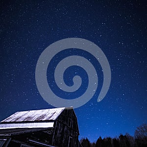 Rural barns at night with stars in winter