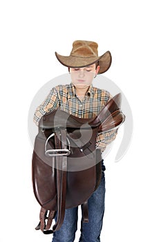 Rural boy holding a saddle