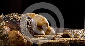 Rural bread and wheat on an old antique wooden table, still life