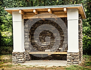 Rural bus stop of stone and wood