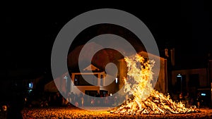 rural celebration in a town with a huge bonfire in the beach