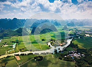 Rural Chinese landscape of limestone rocks and scenic river around rice fields