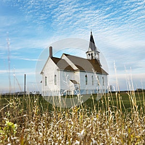 Rural church in field.